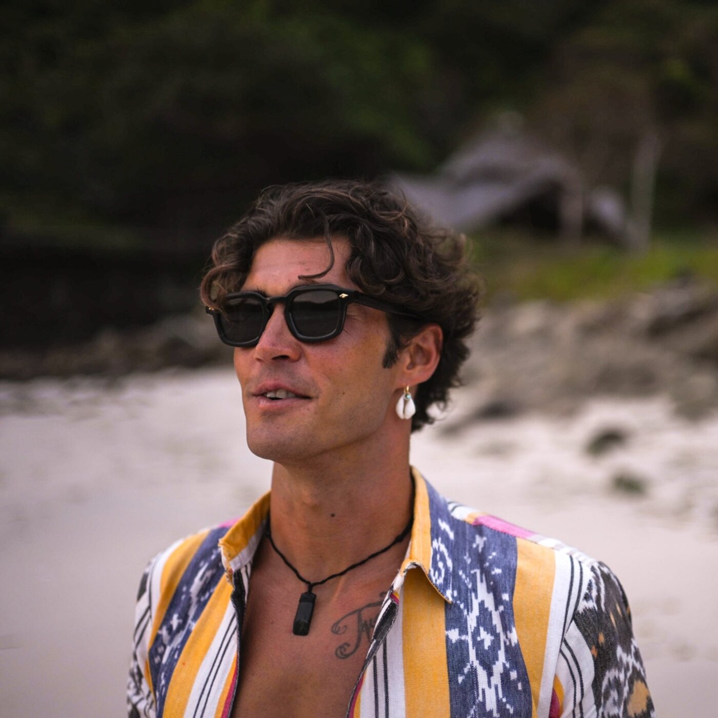 Arthod Eyewear editorial portrait — dark acetate frames, golden hour, Bali coast