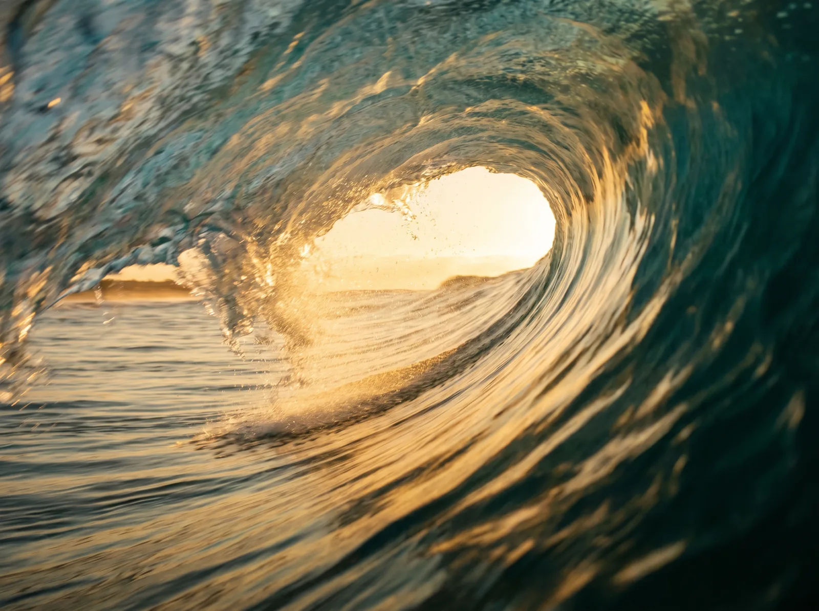View from inside a breaking wave at golden hour
